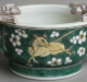 An attractive Chinese cup with leaopard hamdles, decorated on the biscuit with susancai famille verte colours